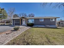 Charming single-story home with gray siding, a carport, and a well-maintained lawn at 3604 Collins St, Castle Rock, CO 80108