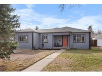 Charming gray single-story home featuring a well-maintained lawn and inviting orange front door at 2381 Newark St, Aurora, CO 80010