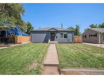 Charming single-story home with well-maintained lawn and inviting walkway at 2465 W Mosier Pl, Denver, CO 80223