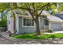 Charming home with a well-manicured lawn and mature trees shading the front at 8056 Meadowdale Sq, Niwot, CO 80503