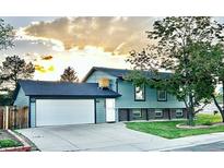 Charming two-story home with a well-maintained lawn and a two car garage at 4303 S Yank St, Morrison, CO 80465