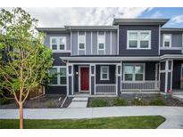 Charming townhouse with a landscaped front yard and a welcoming red front door at 17600 Rose Heath Ln, Parker, CO 80134