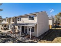 Inviting exterior of a tan-colored townhome featuring a covered porch and well-maintained landscaping at 8915 Field St # 113, Westminster, CO 80021