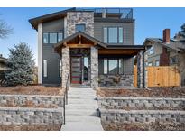 Contemporary two-story home featuring a stone facade, a front porch and a roof-top terrace at 5086 N Raleigh St, Denver, CO 80212