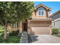 Charming two-story home with a well-manicured lawn and inviting entrance, featuring an attached two-car garage at 12051 E Lake Cir, Greenwood Village, CO 80111