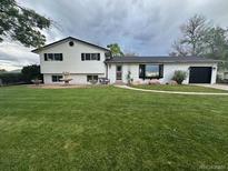 Charming home with a large, well-maintained front yard and decorative fountain at 12901 2Nd St, Parker, CO 80134