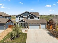Charming two-story home featuring a three car garage, landscaped yard and beautiful stone details at 2757 Stallion Way, Mead, CO 80542