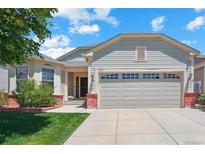 Charming single-Gathering home with a well-maintained lawn and an attached two-car garage at 5740 S Tempe Ct, Aurora, CO 80015