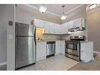 Modern kitchen featuring stainless steel appliances and white cabinetry at 3233 Vallejo St # 3B, Denver, CO 80211