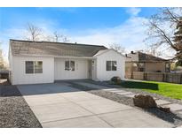 Charming single-story home with a freshly painted white exterior and well-maintained front yard at 4910 Alcott St, Denver, CO 80221