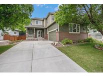 Inviting two-story home features a well-manicured lawn and a long concrete driveway at 3389 Willowrun Dr, Castle Rock, CO 80109