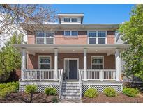Charming two-story brick home with a welcoming front porch and well-maintained landscaping at 3375 N Willow St, Denver, CO 80238