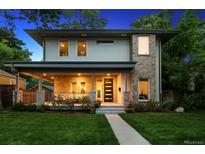 Charming two-story home featuring a welcoming porch and beautifully landscaped front yard at 2377 S Humboldt St, Denver, CO 80210