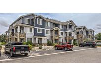 Attractive multi-Gathering condo complex showcasing stone accents, covered balconies, and convenient parking at 5255 Memphis St # 224, Denver, CO 80239