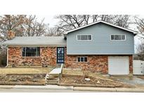 Charming split-level home with brick facade and attached one car garage at 1470 Kennedy Dr, Northglenn, CO 80234