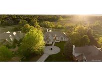 Stunning aerial view of home with mature trees and circle driveway at 4935 E Preserve Ln, Greenwood Village, CO 80121