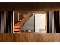 Unique wood staircase with modern design elements and custom wood detailing for a striking architectural statement at 4935 E Preserve Ln, Greenwood Village, CO 80121