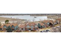 An aerial view of the townhome community near a large lake with walking trails, dam and open spaces at 17467 E Rice Cir # C, Aurora, CO 80015