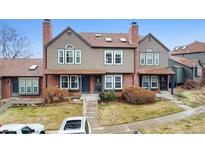 Charming townhome with a well-manicured lawn, brick accents, and a cozy front porch at 17467 E Rice Cir # C, Aurora, CO 80015