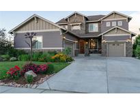 Beautiful two-story home with a landscaped front yard and a long driveway leading to a two-car garage at 13672 Osage St, Broomfield, CO 80023