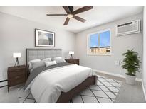 Comfortable bedroom featuring neutral tones, carpet, ceiling fan, and natural light at 155 S Pennsylvania St # 308, Denver, CO 80209