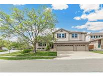 Charming two-story home featuring a three-car garage, landscaped yard, and a beautiful mature tree at 5789 S Jay St, Littleton, CO 80123