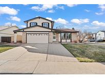 Charming two-story home with a two-car garage and well-maintained front yard at 8405 W 74Th Dr, Arvada, CO 80005