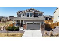 Charming two-story home features a well-manicured lawn, concrete driveway and two-car garage at 13485 Niagara St, Thornton, CO 80602