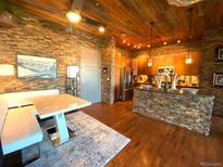 Inviting kitchen and dining area featuring stone accents and modern lighting at 10111 Inverness Main St # 223, Englewood, CO 80112