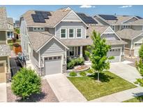 Charming home featuring solar panels, manicured lawn, and welcoming curb appeal at 14565 Vancouver Pl, Parker, CO 80134