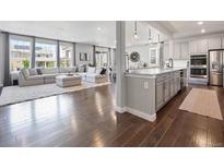 Open living space featuring hardwood floors, large windows, and a cozy seating area at 14565 Vancouver Pl, Parker, CO 80134