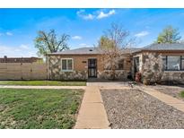 Charming stone-accented home with a well-maintained lawn and inviting curb appeal at 3251 N Adams St, Denver, CO 80205