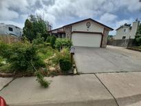 Charming single-Gathering home with stone accents, attached garage, and landscaped front yard at 2758 S Salida St, Aurora, CO 80013