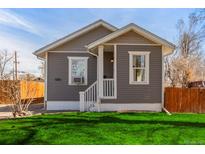 Charming single-story home with gray siding, front porch, and lush green lawn at 1350 Valentia St, Denver, CO 80220