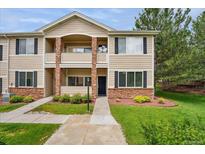 Charming two-story townhome with well-maintained landscaping, stone accents, and inviting front entry at 16848 E Gunnison Dr # 9E, Aurora, CO 80017