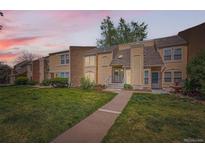 Charming townhome with landscaped front yard and inviting entryway at sunset at 13020 E Linvale Pl, Aurora, CO 80014