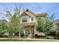 Charming two-story home featuring a welcoming front porch and well-maintained landscaping at 10671 E 28Th Ave, Denver, CO 80238