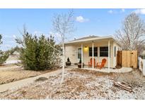 Charming single-story home with a covered porch and inviting curb appeal at 1920 Ulster St, Denver, CO 80220