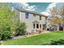 Spacious backyard with a well-maintained lawn, patio, fire pit, and outdoor seating area for relaxing and entertaining at 15432 Greenstone Cir, Parker, CO 80134