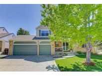 Charming two-story home with a three-car garage and beautiful landscaping in a suburban neighborhood at 15432 Greenstone Cir, Parker, CO 80134