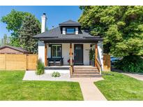 Charming home with a cozy front porch, manicured lawn, and inviting curb appeal at 4467 King St, Denver, CO 80211