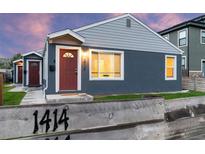 Charming single-story home with a manicured lawn, blue siding, and a red front door, exuding curb appeal at 1414 W Nevada Pl, Denver, CO 80223