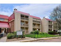 Condominium building with red roof, multiple units, balconies, and well-maintained landscaping at 14700 E Kentucky Dr # 524, Aurora, CO 80012
