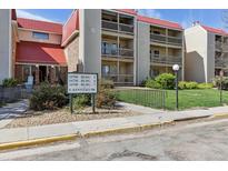 Exterior of condominium complex with red roofing and well-manicured landscaping at 14700 E Kentucky Dr # 524, Aurora, CO 80012