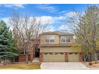 Charming two-story home with a well-manicured lawn and a three-car garage at 9743 Las Colinas Dr, Lone Tree, CO 80124