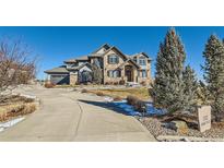 Two-story home with stone facade and landscaped yard at 15102 Prairie Pl, Broomfield, CO 80023