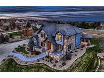 Luxury home with a three-car garage and manicured lawn at 15102 Prairie Pl, Broomfield, CO 80023