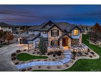 Beautiful two-story home with stone accents, manicured lawn, and inviting stone walkway leading to the front door at 15102 Prairie Pl, Broomfield, CO 80023