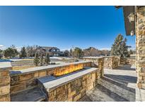 Outdoor fireplace and seating area provides a view of the neighborhood at 15102 Prairie Pl, Broomfield, CO 80023