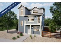 Charming two-story home with blue siding, white trim, balcony, and gravel front yard at 13548 E 103Rd Pl, Commerce City, CO 80022